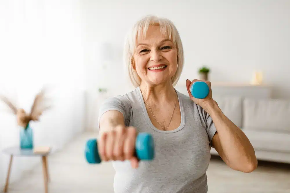 mature,woman,exercising,at,home,with,two,dumbbells