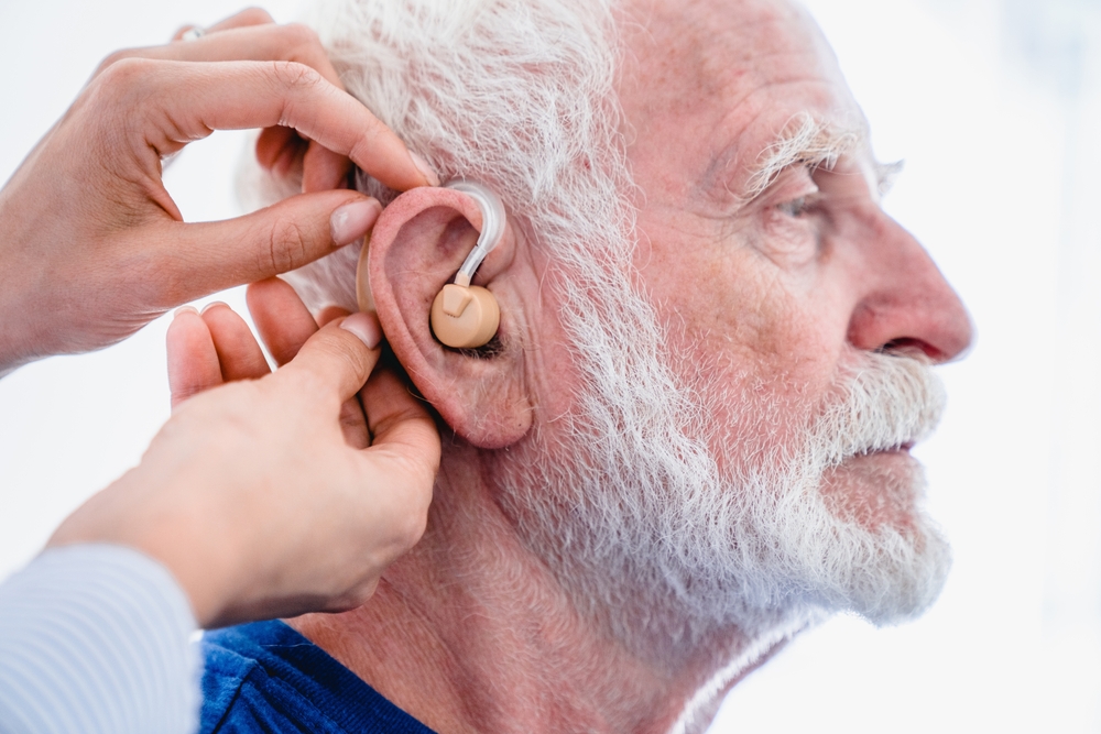 side,view,of,male,senior,patient,with,hearing,aid,being