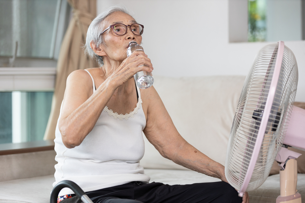 old,elderly,woman,drinking,a,bottle,of,water,keeping,body,water