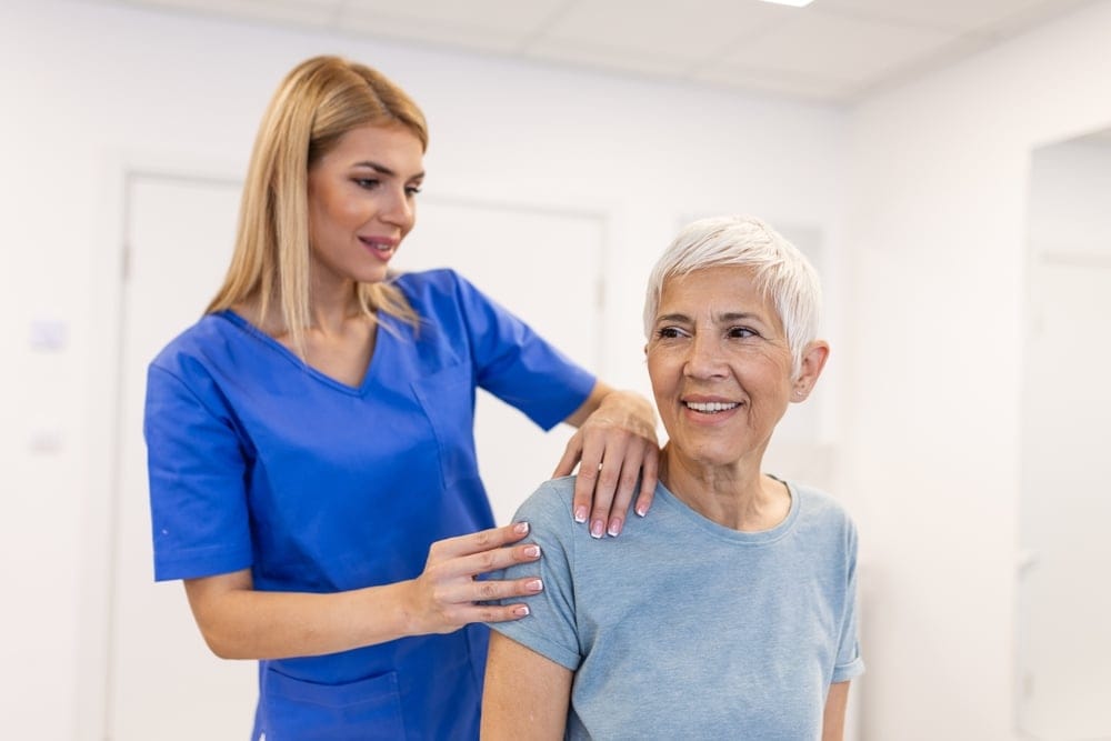 woman,doctor,osteopath,in,medical,uniform,fixing,senior,woman,patients