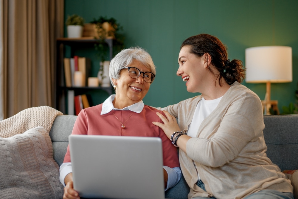 young,and,senior,women,are,using,laptop,pc.,daughter,is