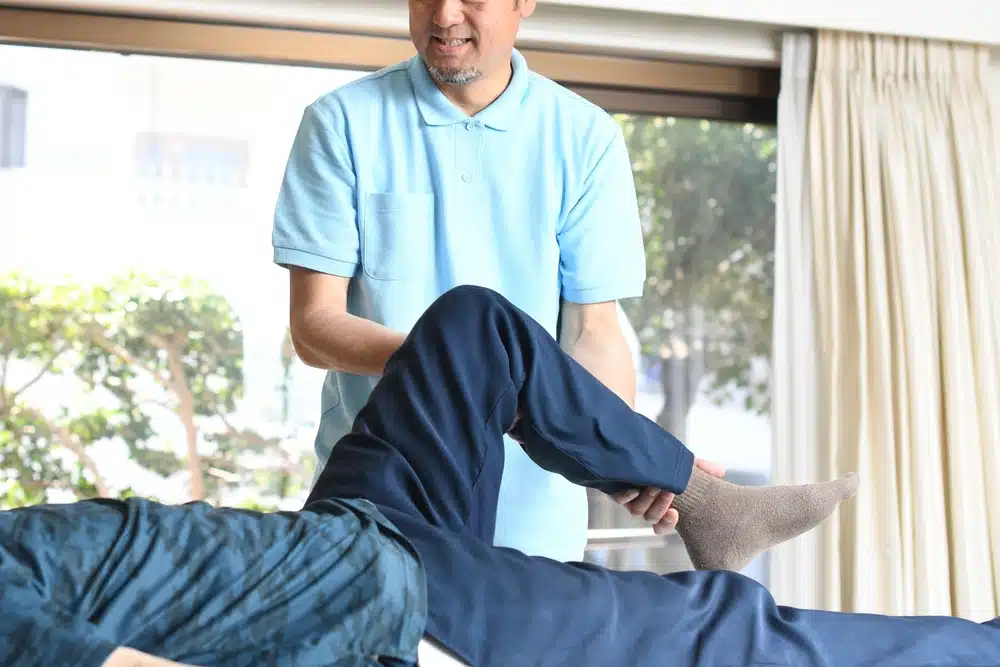 male,chiropractor,and,male,elderly,patient,who,perform,leg,massage