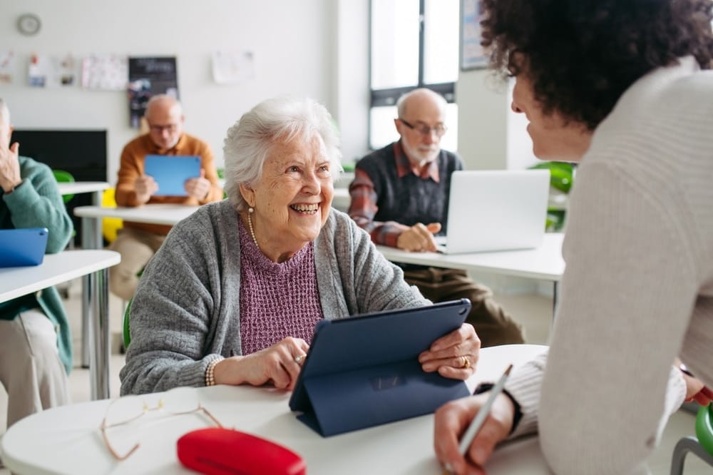 elderly,woman,learning,digital,skills,with,tutor,help.