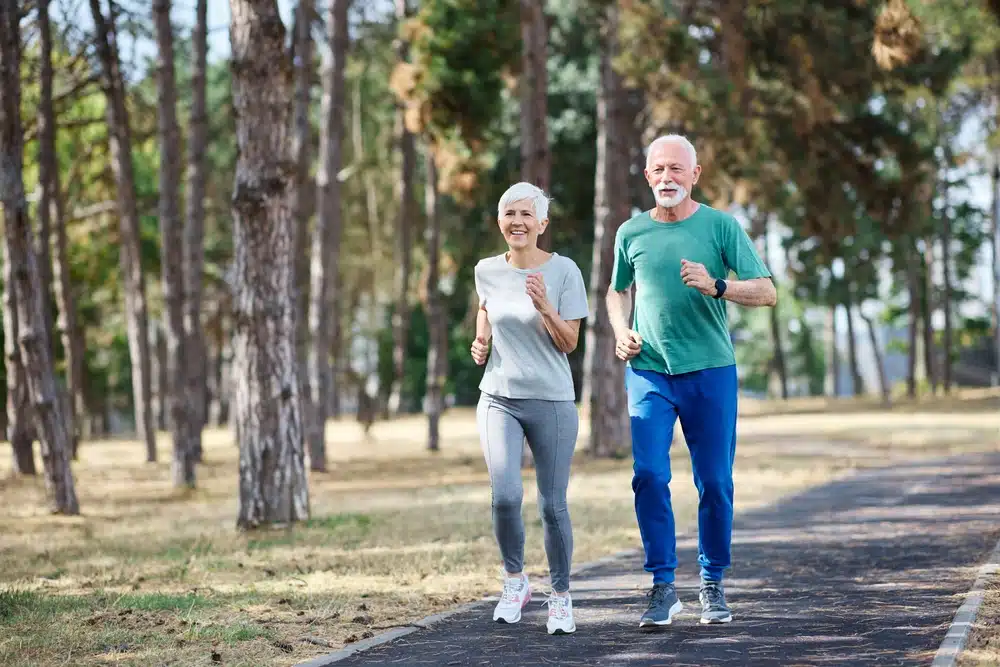 smiling,active,mature,senior,couple,jogging,together,in,the,park