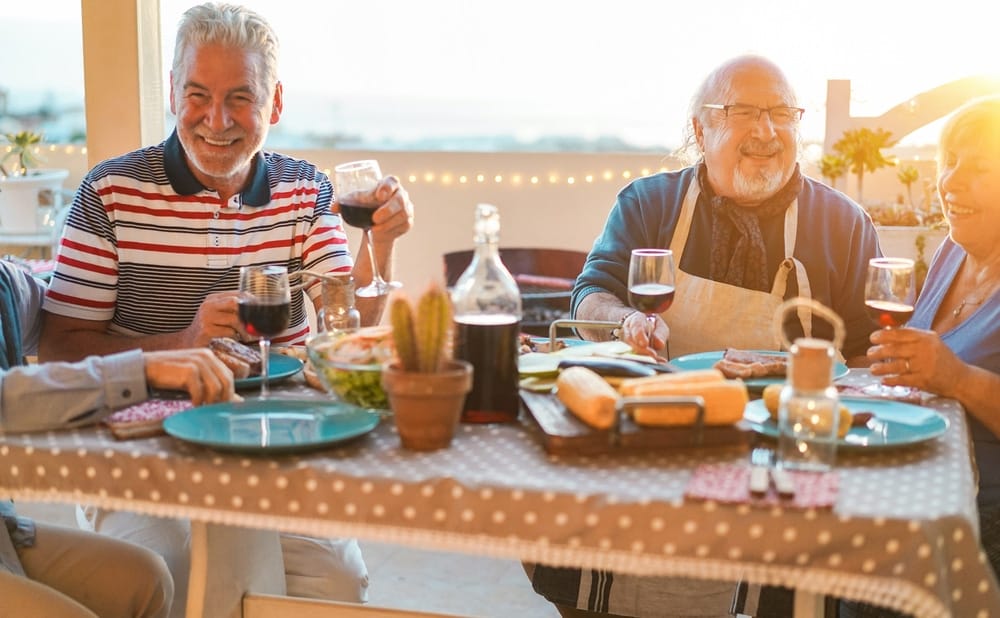 group,of,happy,senior,friends,at,barbecue,meal,in,terrace
