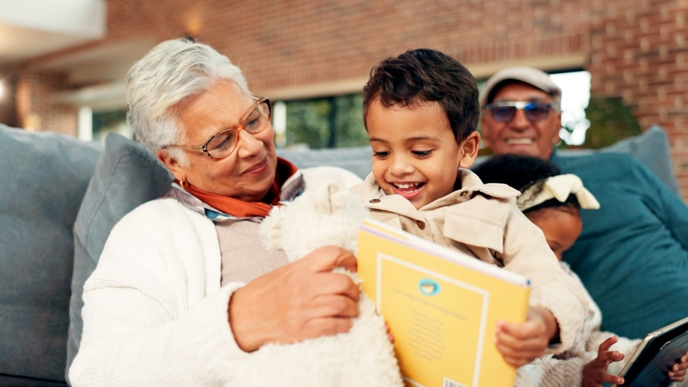 grandmother,,boy,and,reading,book,on,sofa,with,learning,,happy