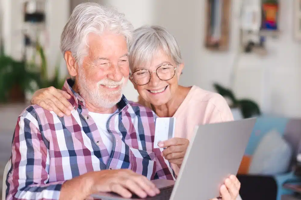 elderly,couple,browsing,by,laptop,enjoying,shopping,online.,joyful,and