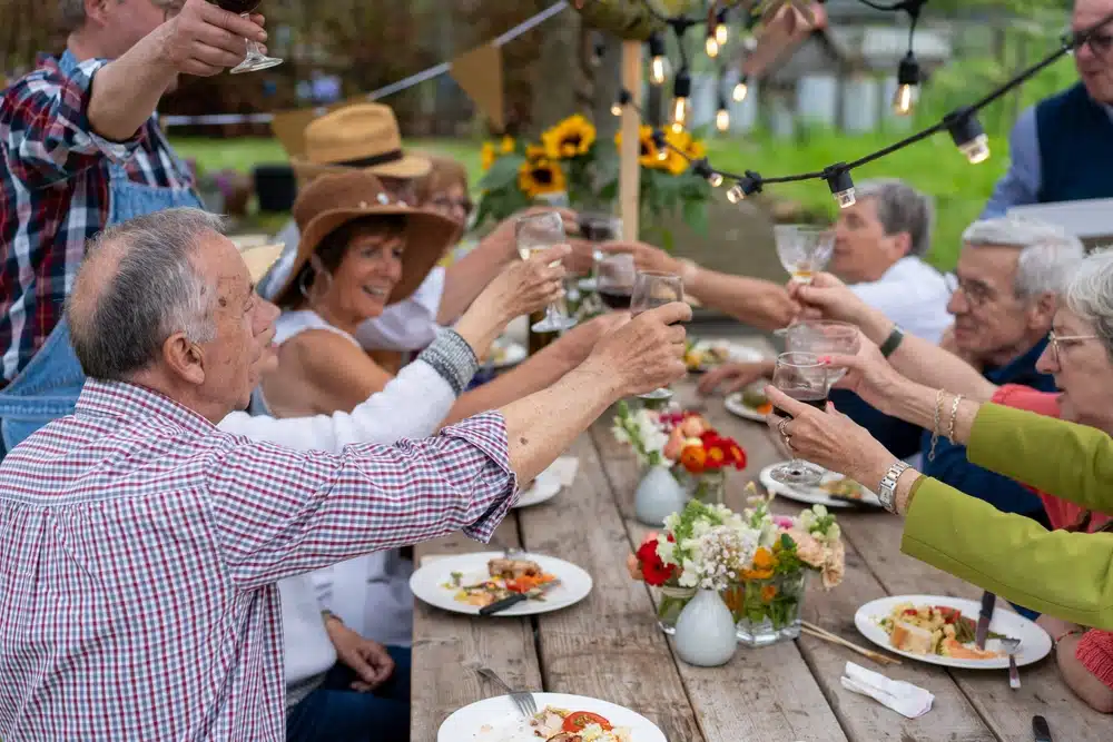 group,of,senior,friends,raising,glasses,in,a,toast,during