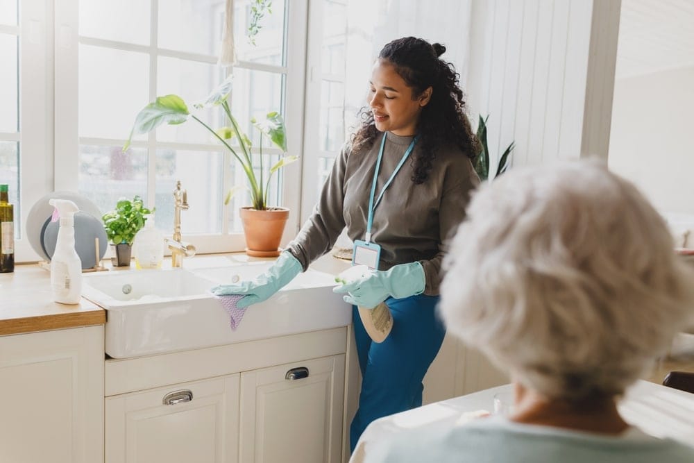 rare,view,of,gray haired,lady,talking,to,black,helping,volunteer