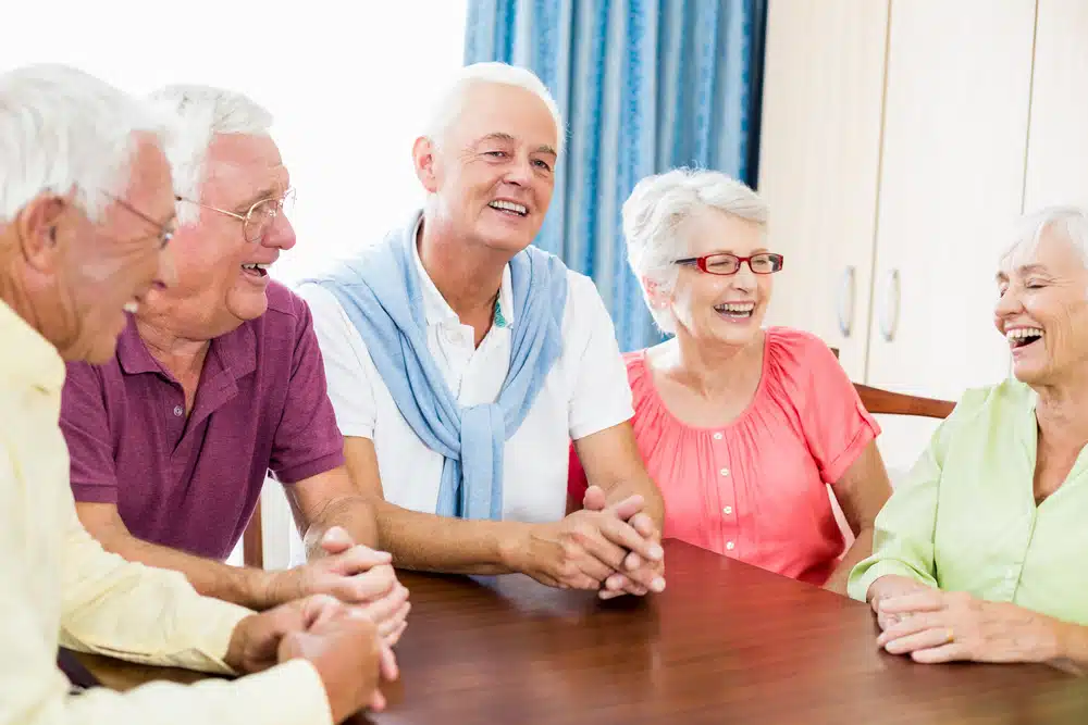 seniors,talking,at,table,in,a,retirement,home