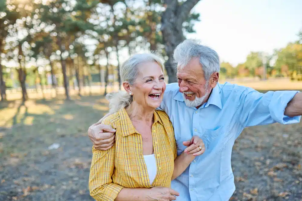 happy,active,senior,couple,having,fun,talking,holding,hands,and