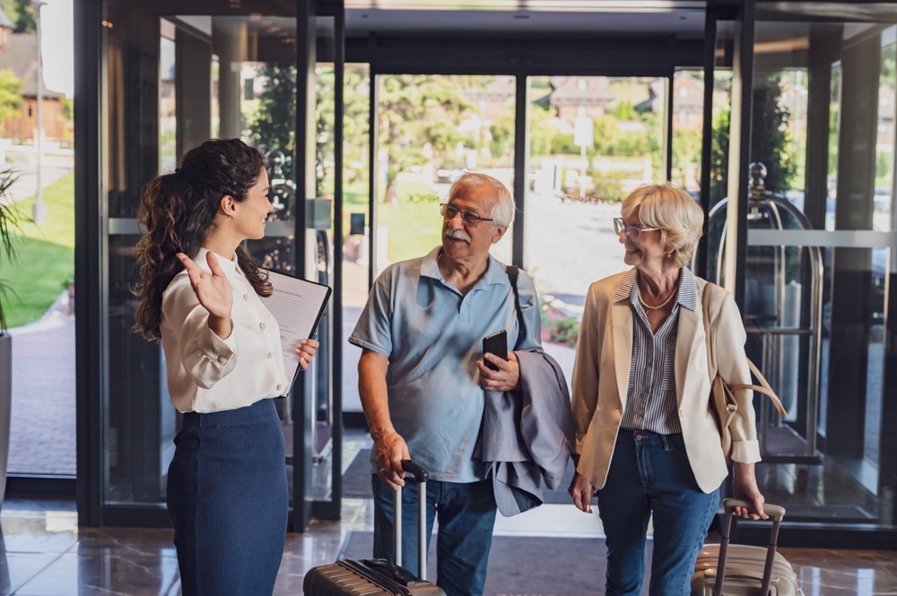 a,senior,couple,is,arriving,at,the,hotel,with,luggage,