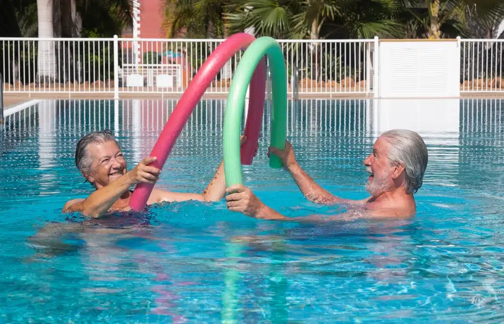 cheerful,happy,senior,couple,having,fun,in,outdoors,swimming,pool