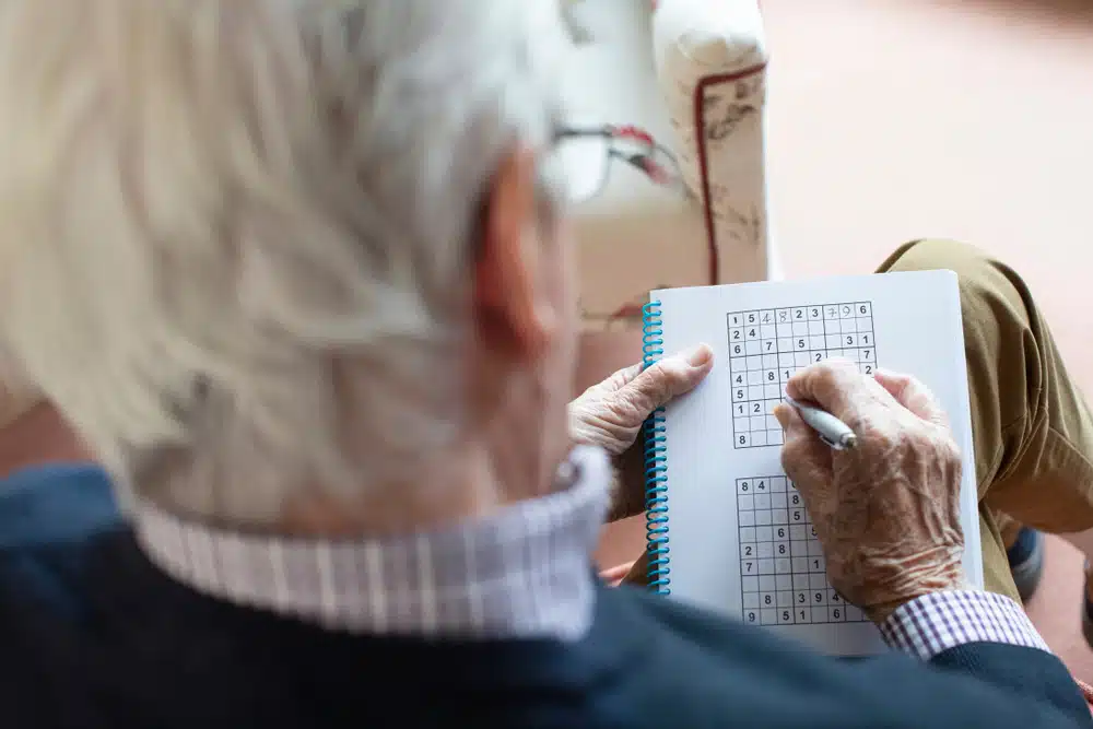 senior,man,doing,sudoku,puzzle,at,home