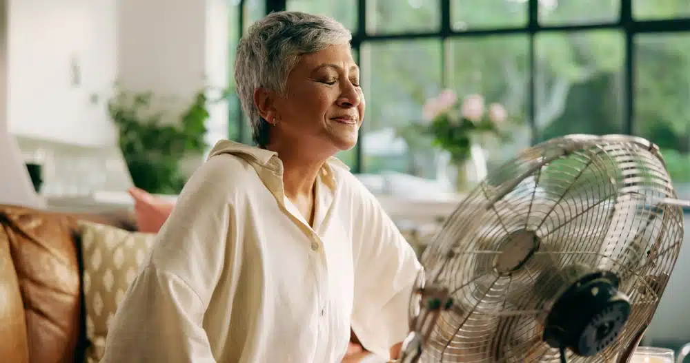 elderly,woman,,hot,and,fan,at,house,for,heatwave,,air