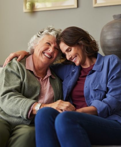 beautiful,old,mother,and,her,daughter,smiling,warmly,while,embracing