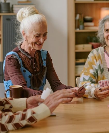 senior,people,smiling,and,enjoying,playing,cards,together,in,nursing