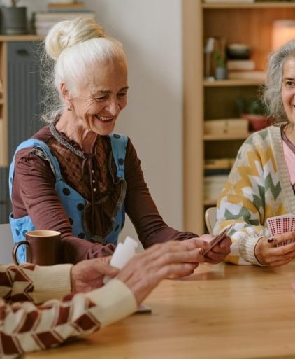 senior,people,smiling,and,enjoying,playing,cards,together,in,nursing